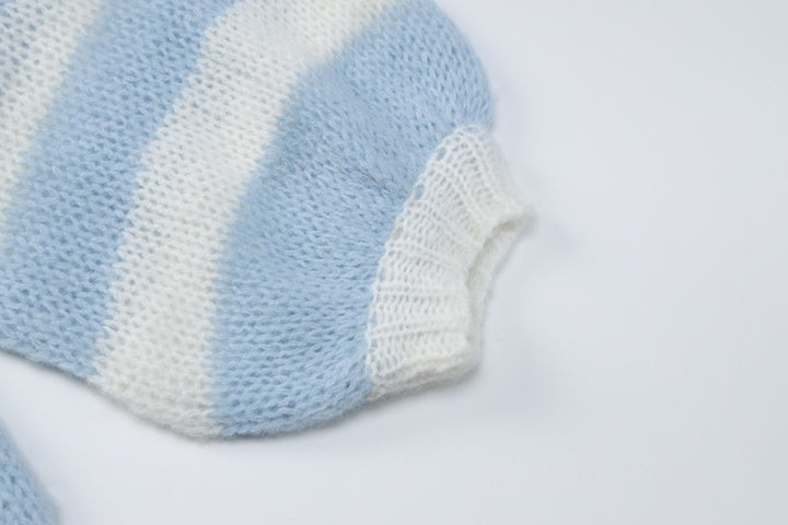 Light blue and white striped knitted fabric, showcasing the cuff detail of a cozy lingerie or nightwear top.