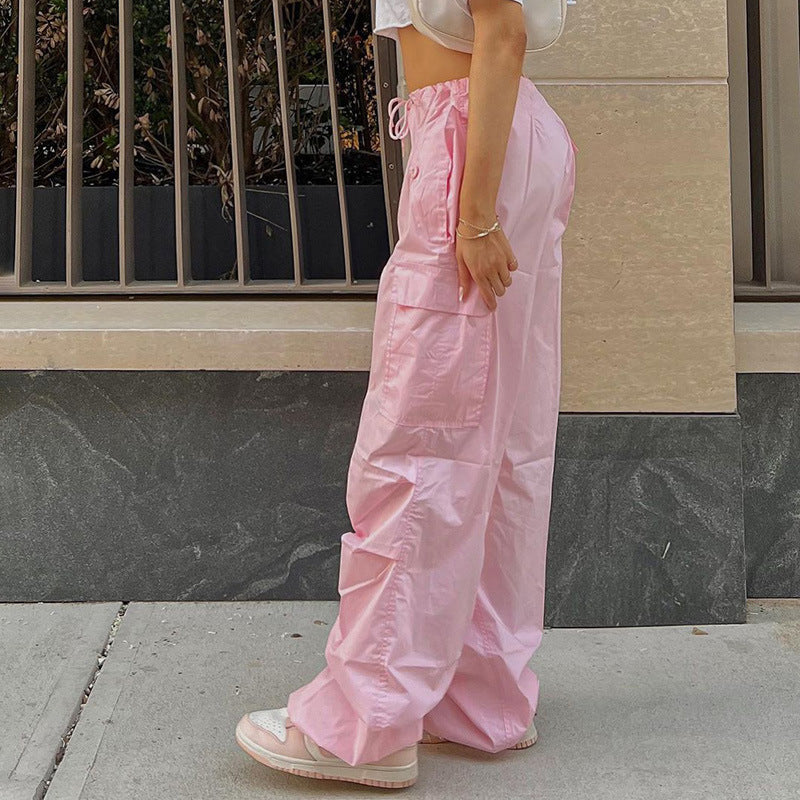 Pink wide-leg lounge pants styled with a cropped white top, perfect for relaxed occasions.