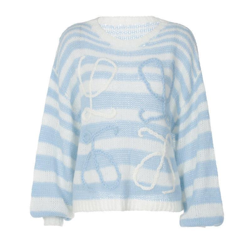 Cozy light blue and white striped sweater with oversized fit and playful knitted detail.