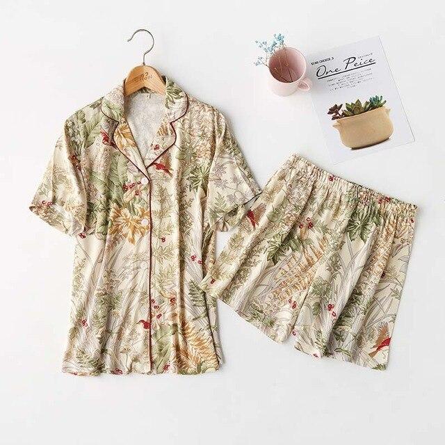 Floral print women's short pajama set featuring a short-sleeve button-up top and elastic waist shorts, perfect for comfortable sleepwear.