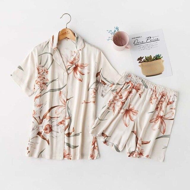 Floral print short-sleeve pajama set featuring a button-up shirt and matching shorts, perfect for comfortable sleepwear.