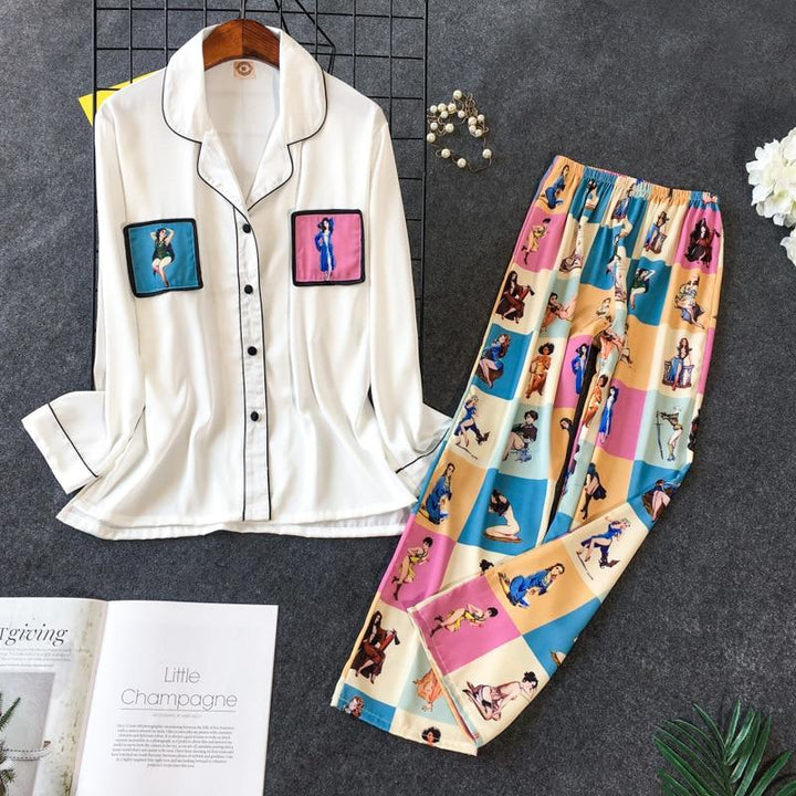 Women's stylish white long-sleeve pajama set featuring colorful patterned pants and playful graphic pockets. Perfect for comfort and fun at home.