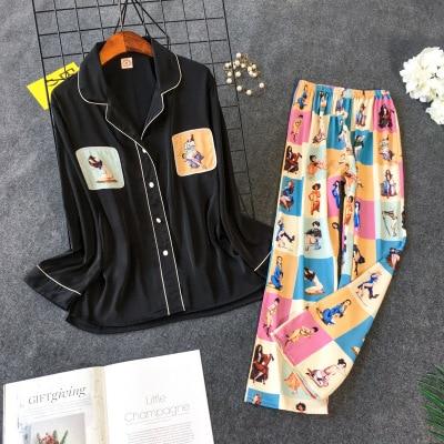 Black pajama set with playful illustrated print pants and matching button-up top for comfortable and stylish nightwear.