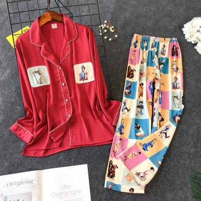 Red satin pajama set with playful printed pants featuring colorful illustrations, perfect for stylish and comfortable sleepwear.