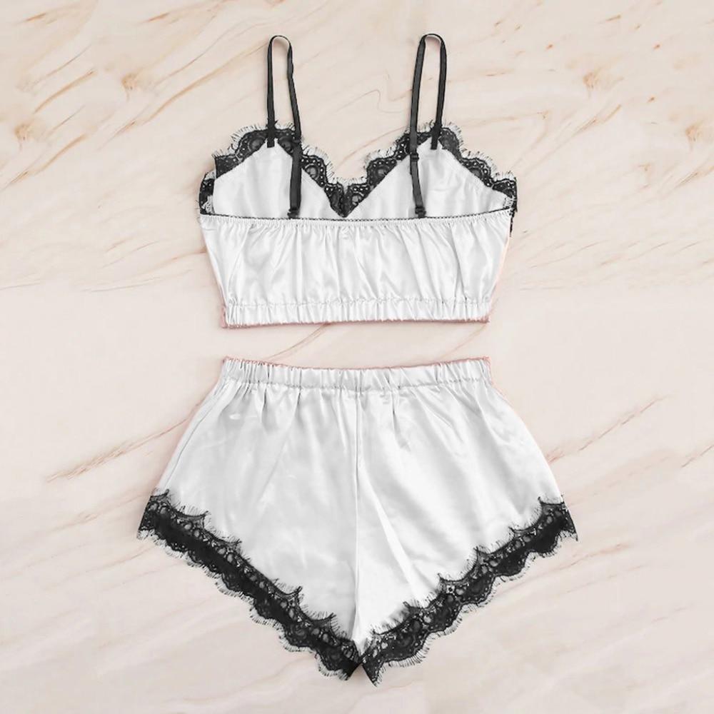 White satin lingerie set featuring a lace-trimmed bralette and matching shorts, ideal for a stylish and comfortable nightwear look.