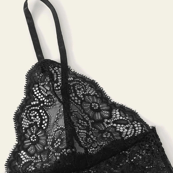 Elegant black lace bralette with adjustable straps and floral detailing, perfect for layering or wearing alone as nightwear.