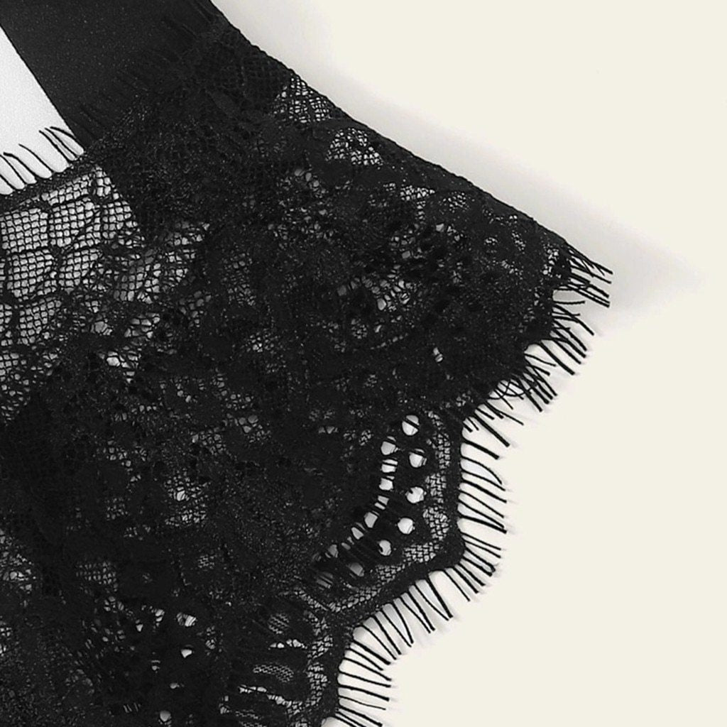 Detailed close-up of luxurious black lace trim on elegant lingerie fabric, showcasing intricate patterns and delicate texture.