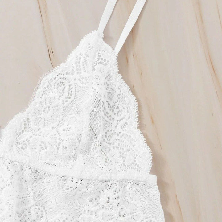 White lace bralette featuring delicate floral patterns and adjustable straps, ideal for layering or intimate wear.