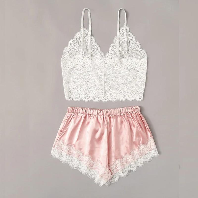 Lace bralette with adjustable straps and silky pink shorts featuring lace trim, perfect for cozy nights.