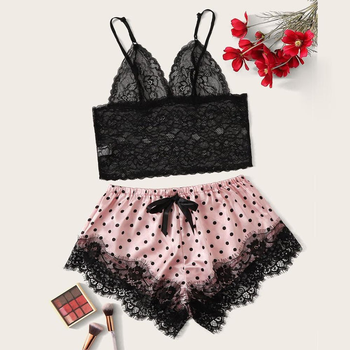 Black lace bralette paired with pink polka dot shorts featuring black lace trim and bow detail, perfect for a stylish nightwear look.