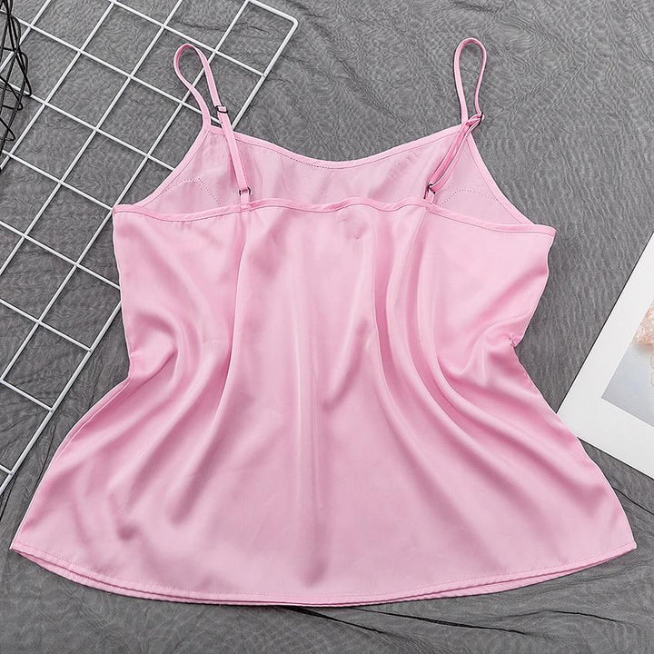 Pink satin camisole top with adjustable spaghetti straps, perfect for lingerie and nightwear collections.