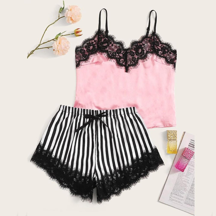 Pink lace-trimmed camisole and black striped shorts set with floral accents, perfect for lounging and bedtime.