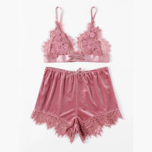 Lace bralette and matching shorts set in soft pink with delicate floral detailing and satin finish.