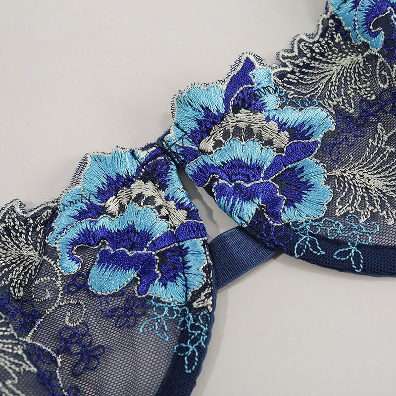 Embroidered lace bra with intricate blue floral designs and a navy base, ideal for elegant and stylish lingerie collections.