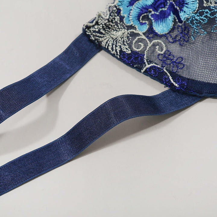 Delicate blue floral embroidered bralette featuring satin straps on a light background.