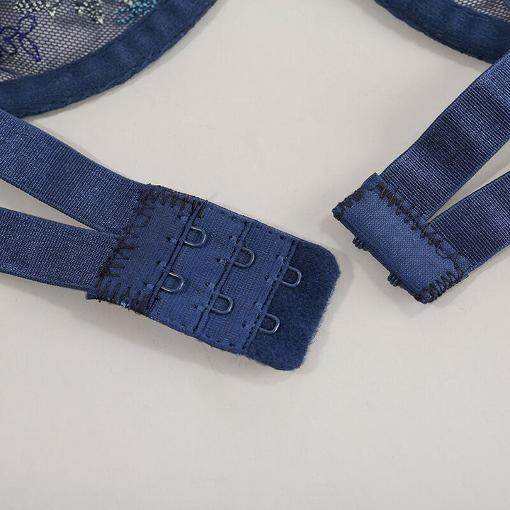 Close-up of blue lingerie straps and hooks, showcasing adjustable features for a comfortable fit.