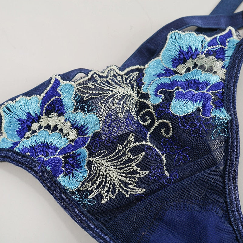 Elegant navy blue lace bralette with intricate floral embroidery in shades of blue and silver, perfect for adding a touch of sophistication to your lingerie collection.